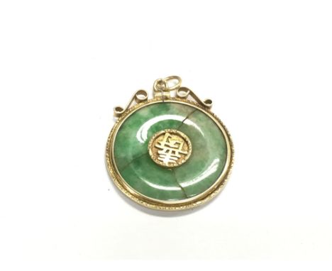 A Chinese jade pendant inset in an unmarked gold mount. Approx 30mm diameter.