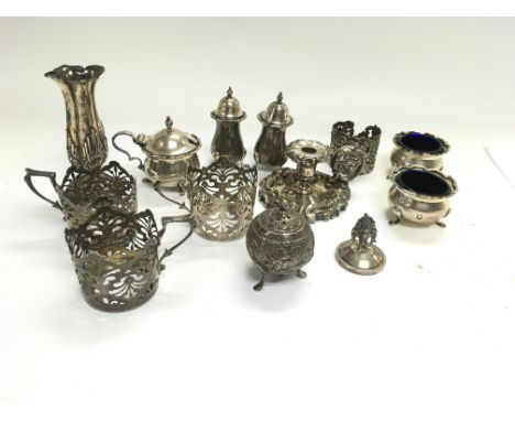 A collection of assorted silver items including shakers, vase, candlestick holder etc. Approx 490g total.