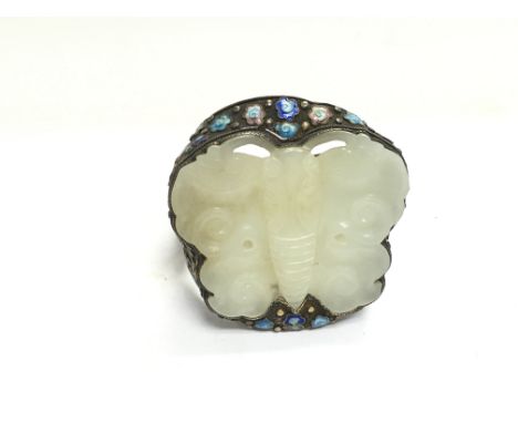 A large silver and jade bangle carved in the form of a butterfly with cloisonnÃ© decoration.