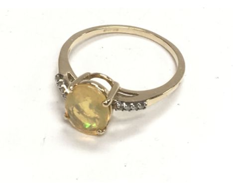 9ct yellow gold oval cut yellow opal ring with diamond set twist shoulders, boxed. Ring size S. Postage category A.