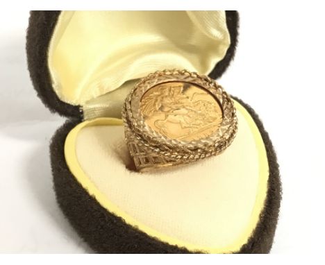 A 9 carat gold ring set with a half sovereign H/I. 8.4g Postage category A