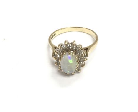 A 9ct gold ring set with opal and white stones. Size N and 3.22g. Postage A