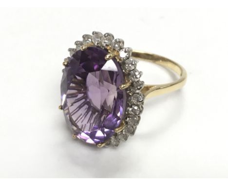 18ct yellow and white gold ring multi claw set with a large oval amethyst surrounded by RBC diamonds. Amethyst 10.00ct. Diamo