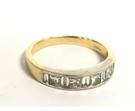An 18 carat gold ring set with a single row of diamonds ,size N/O 3.5g. Postage category A