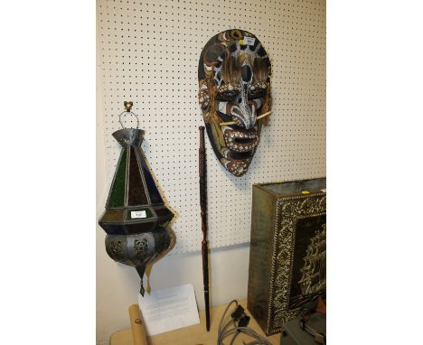 A TREEN PAPUA NEW GUINEA FUNERAL MASK DECORATED WITH SEASHELLS AND ANIMAL BONE TOGETHER WITH A MODERN TRIBAL STYLE SWAGGER ST