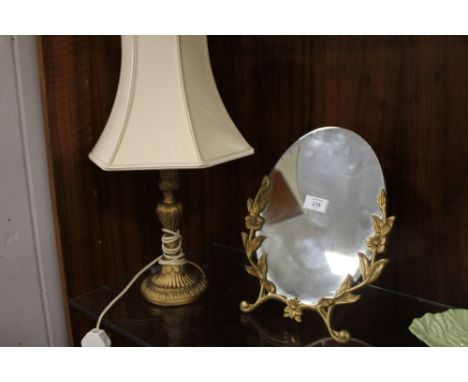 A MODERN BRASS EFFECT MIRROR ON STAND TOGETHER WITH A BRASS EFFECT LAMP (2)