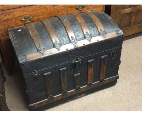 A quality Victorian dome top travelling trunk with wood and metal bound over leather.