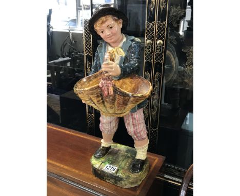 A large ceramic figure of a boy holing a basket. 50cm. NO RESERVE