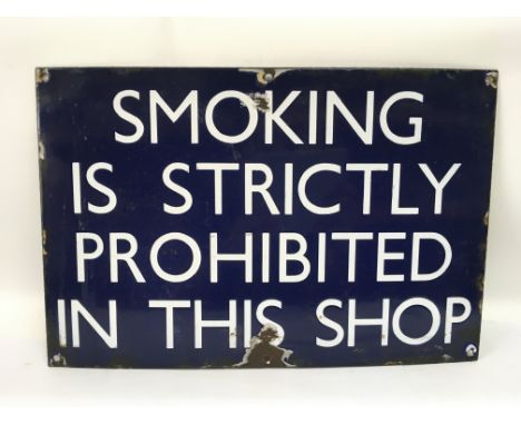 An enamel shop sign 'Smoking Is Strictly Prohibited In This Shop', approx 46cm x 30cm. Shipping category D.