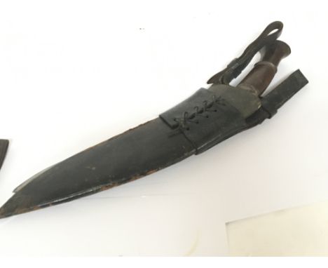 An old Kukri knife with leather scabbard.