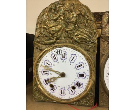 Two continental brass wall clocks with raised figures the enamel dial With Roman numerals with pendulums.