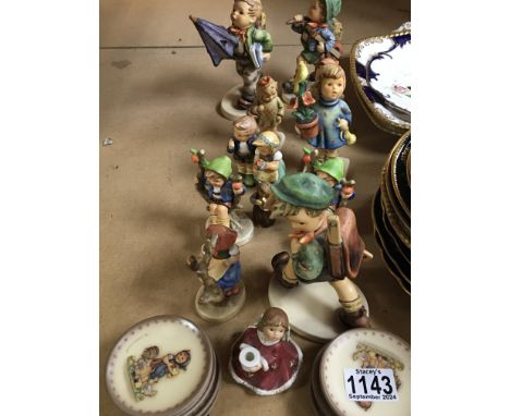 A collection of Hummel figures and small collectors plates no obvious damage.