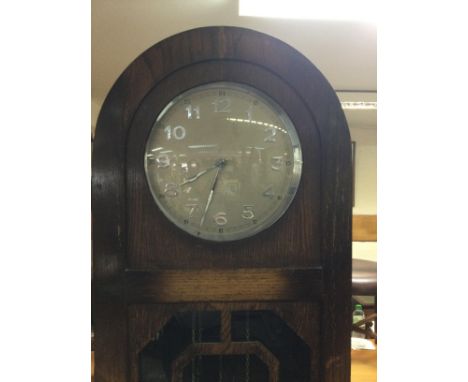A oak three train longcase clock the circular dial with Arabic numerals.