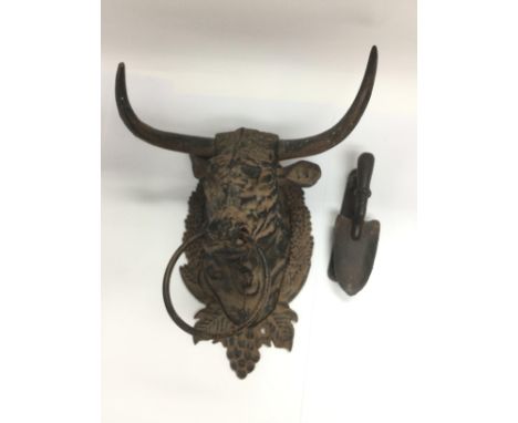 A cast metal wall mounted bull's head and a novelty door knocker in the form of a trowel (2). Shipping category D.