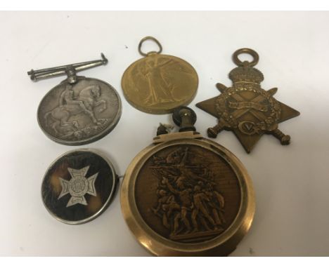 A Group of I world war medals awarded to 3063 SJT E.R Hibburt MIDD X REG a silver and tortershell badge and a I World War Tre