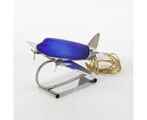 Sarsaparilla. an art deco style table lamp.&nbsp;The moulded blue glass lamp in the form of a DC3 aircraft, raised on a chrom