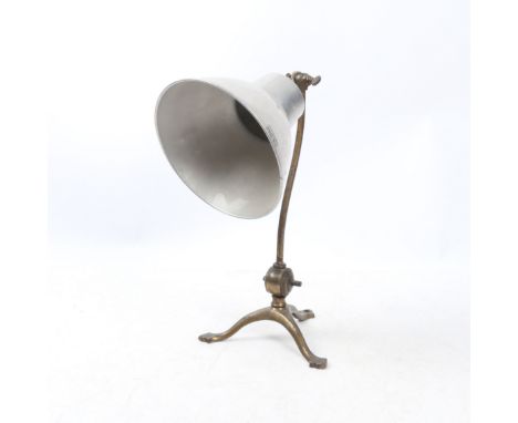 W. A. S. Benson. a brass adjustable table lamp.&nbsp;The curved arm stamped AAS Benson to the bolts above squat arced support