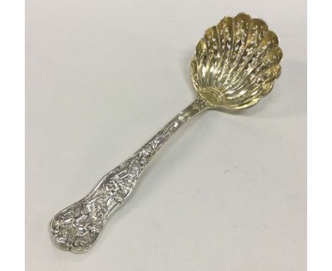 A pierced silver chased Bacchanalian pattern sifter ladle. London 1874. Approx. 60 grams. Est. £180 - £220.