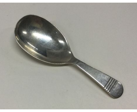 A silver caddy spoon with line decoration to handle. Birmingham 1971. By Turner &amp; Simpson (?). Approx. 17 grams. Est. £30