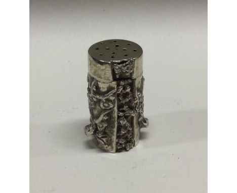 A Chinese silver pepper with chased and hammered decoration. Approx. 45 grams. Est. £80 - £120.