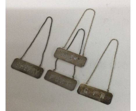 A rare set of four Chinese silver wine labels. Approx. 35 grams. Est. £100 - £150.