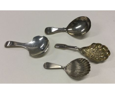 Four various Georgian silver caddy spoons to include an embossed gilt example by Joseph Taylor. Approx. 47 grams. Est. £40 - 