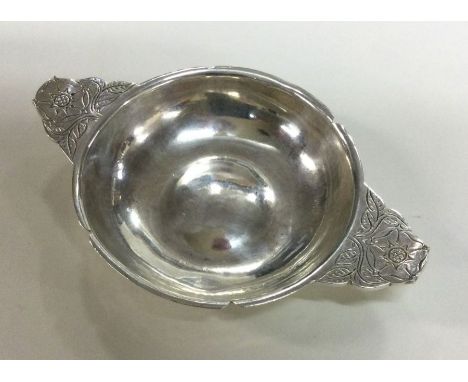 A silver wine taster. London 1946. By R E Stone. Approx. 89 grams. Est. £200 - £300. 