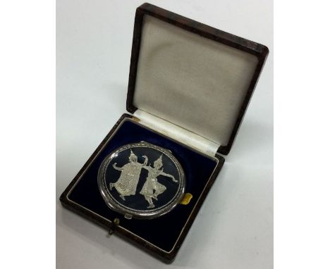 A cased Thai silver and Niello compact. Approx. 65 grams. Est. £40 - £60.