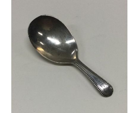An 18th Century Provincial silver caddy spoon with beaded decoration. Makers mark only. Approx. 14 grams. Est. £40 - £60.