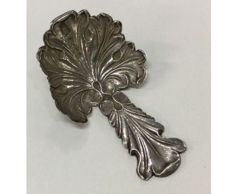 A Cast Victorian silver caddy spoon. Birmingham 1854. By G Wheeler &amp; Co. Approx. 11 grams. Est. £20 - £30.