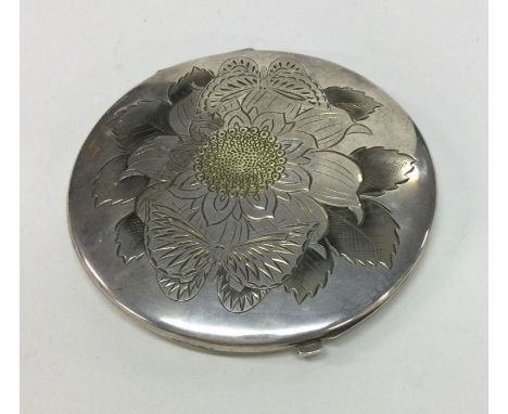 A large Japanese silver compact. Signed. Approx. 183 grams. Est. £200 - £250.