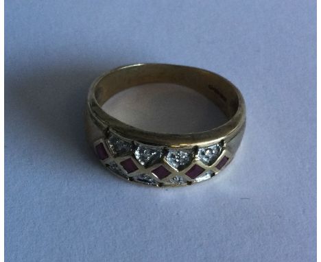 A ruby and diamond mounted three row ring in 9 carat setting. Approx. 3 grams. Est. £40 - £60.