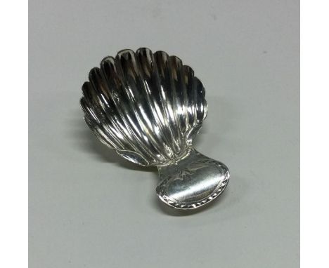 A bright cut George III silver caddy spoon with fluted bowl. Circa 1810. Approx. 8 grams. Est. £40 - £60.