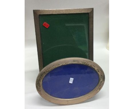 A good engine turned silver picture frame together with an oval example. Est. £50 - £80.