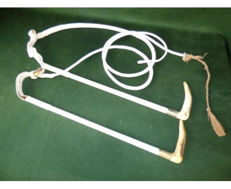 Two white hunting whips with stag horn handles by Swaine Aidney and Brigg, one with silver collar