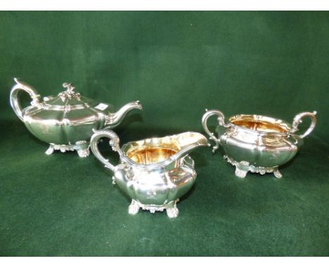 Early Victorian silver three piece tea service, the panelled body engraved a wheatsheaf crest, teapot with swan neck spout, c