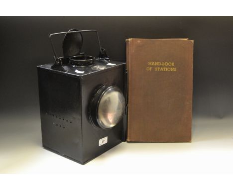 Railwayana - a bound copy of handbook of stations 1956; a LMS railway lantern (2)