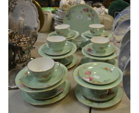 A Worcester part tea service painted with floral bouquets on an apple green ground 