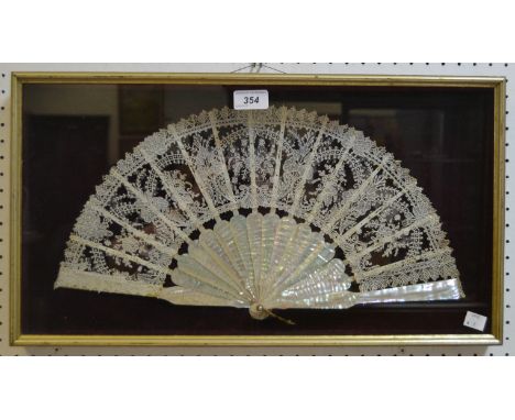 A 19th century French mother-of-pearl and lace fan,  sixteen sticks and guards pierced 45cm wide, glazed case