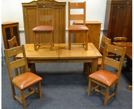 A contemporary light oak extendable dining table, a set of six conforming dining chairs, tanned leather seats (7)