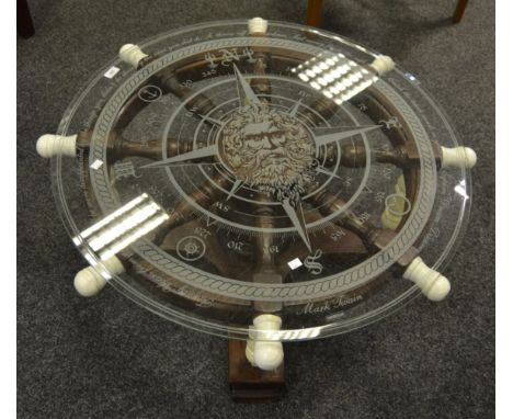 A late 20th Century occasional table in the form of a ship's wheel, glass top engraved with compass points