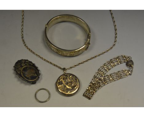 A silver hinged bangle; a gate bracelet; silver locket; a Victorian silver brooch; ring (5)