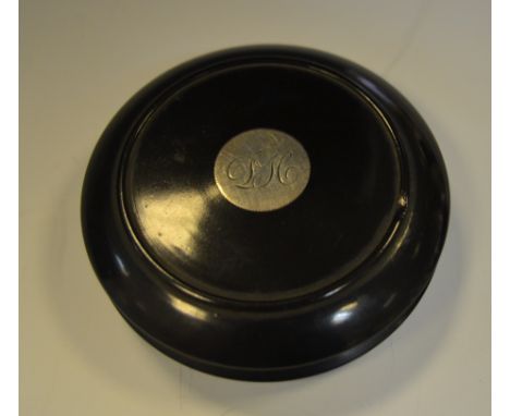 A Victorian ebonised circular snuff box, the cover set with a silver coloured metal roundel, c.1880