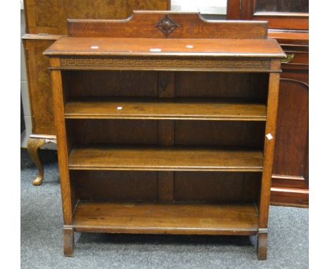 A mid 20th century oak open shelf bookcase, Greek key carved frieze, c.1950