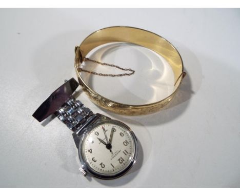 An Ingersoll 7 jewel lever nurse's watch and an H.G. & S 9ct metal core p/s z lady's bangle with safety chain and scrolling d