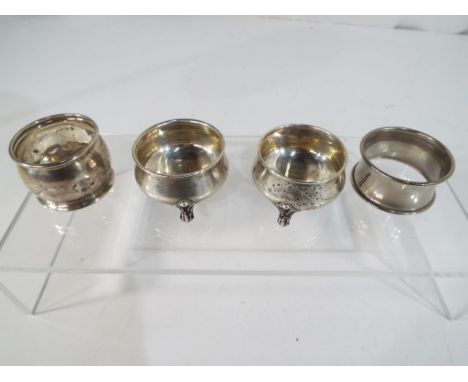 A pair of European silver salts stamped 800 on scroll feet, a hallmarked silver napkin ring, Birmingham assay and a further w