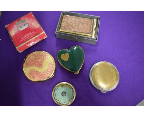 Five vintage compacts, including one gold plated L'aimant 75 year anniversary compact and a musical example.
