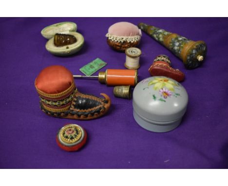 A selection of sewing collectables, including cut glass thimble in egg shaped green velvet box, tin of needles and painted tr