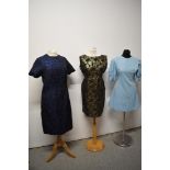 Three 1960s dresses, including two with metallic thread accents and baby blue mini dress with puff