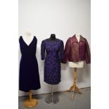 Two purple 1960s dresses and a cerise and gold jacket, having Art Deco styling.